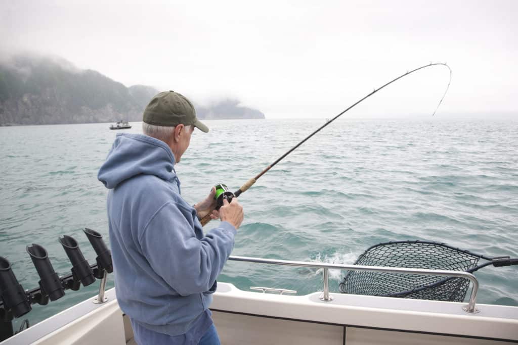 Man catches salmon on Alaska fishing trip in Kodiak