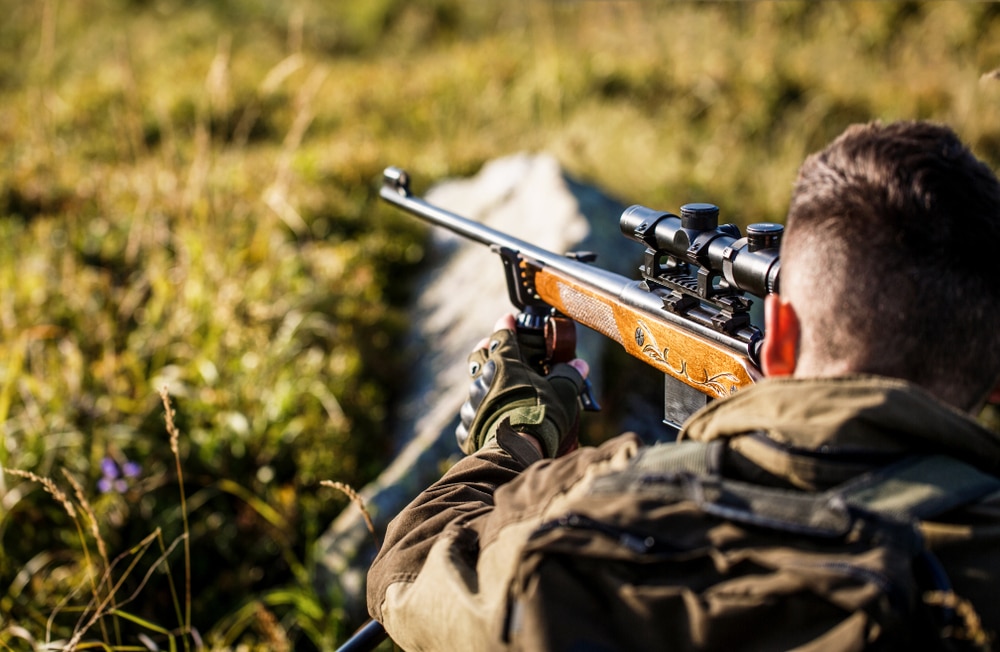 Man with a gun hunting alone on kodiak island