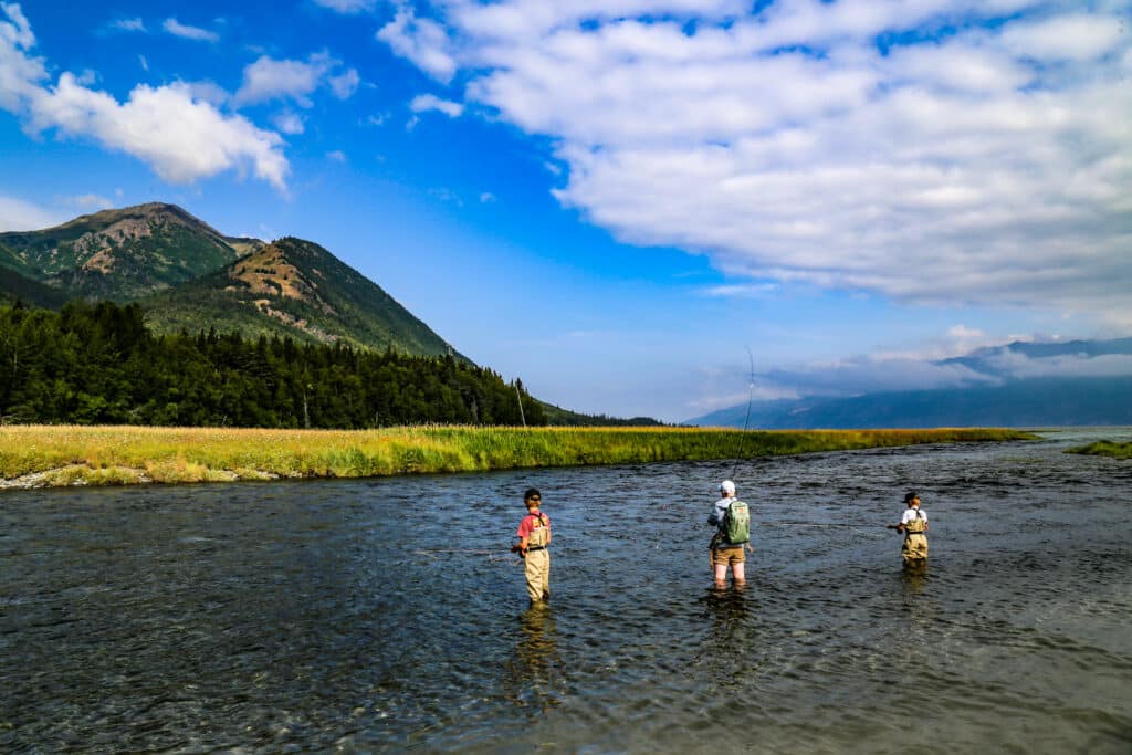 boys fly fishing for salmon on resurrection creek